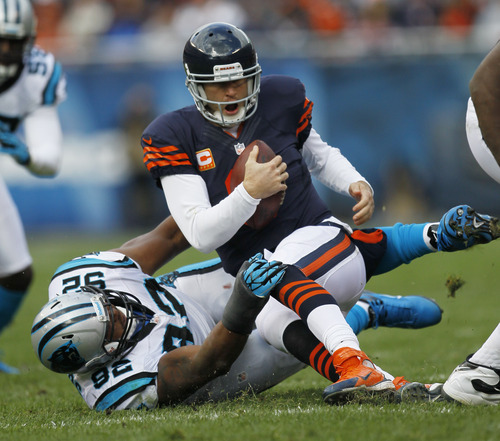 Chicago Bears quarterback Jay Cutler (6) is tackled by Carolina Panthers defensive tackle Dwan Edwards (92) during the first half of an NFL football game in Chicago, Sunday, Oct. 28, 2012. (AP Photo/Charles Rex Arbogast)