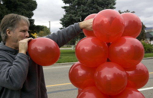 Kim Raff | The Salt Lake Tribune
Steve Nielsen, owner of Balloon Bonanza, sets up columns of air-filled balloons he now uses more of because of the national shortage of helium, before the Leukemia and Lymphoma Society's Light the Night Walk at Sugarhouse Park in Salt Lake City on Saturday, October 13, 2012.
