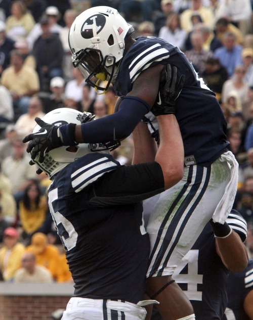 Rick Egan  | The Salt Lake Tribune 

Brigham Young Cougars offensive linesman Braden Brown (75) lifts Brigham Young Cougars running back Jamaal Williams (21) up into the air, after Williams scored for BYU in game action against Georgia Tech, at Bobby Dodd Stadium in Atlanta, Saturday, October 27, 2012