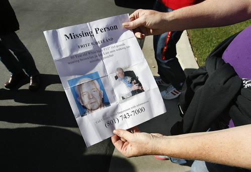 Scott Sommerdorf  |  The Salt Lake Tribune              
Volunteers study the flyer showing photos of missing 80 year old Fritz Helland, and his dog, Sunday, October 28, 2012.