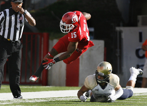 Scott Sommerdorf  |  The Salt Lake Tribune             
Utah RB John White IV is sent airborne on this tackle during early first quarter play. Utah held a 7-0 lead over Northern Colorado early in the second quarter on Jordan Wynn's 10-yard TD pass to Jake Murphy, Thursday, August 30, 2012.