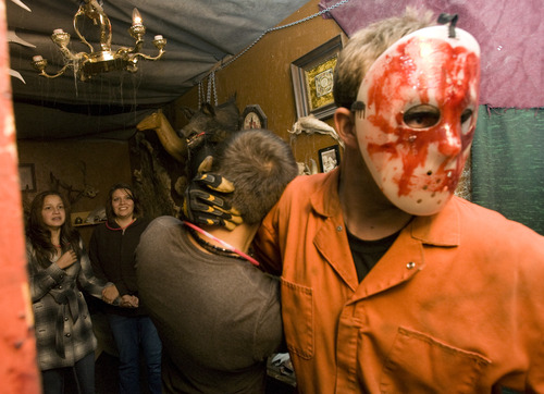 Kim Raff | The Salt Lake Tribune
(right) Sheldon Smith grabs a person walking through the Castle of Chaos haunted house in Taylorsville, Utah on October 29, 2012.
