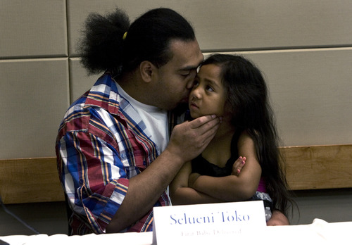 Scott Sommerdorf  |  The Salt Lake Tribune              
Father Apollo Toko, kisses his daughter Selueni Toko as they attended the Intermountain Medical Center's 5th anniversary, Monday, October 29, 2012. Selueni was the first baby delivered at the hospital on Oct 29th, 2007.
