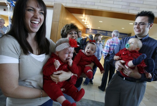 The first Intermountain Medical Center patients to be admitted in Murray one year ago, triplets Natalia, Jenessa and Connor Nagel, from left, are held by their mother Jodi Nagel, left, grandma Casey Nagel, center, and their father Paul Nagel as they begin to show their approaching nap time before the start of celebrations at the hospital.  The triplets were on hand for the hospital's one-year-anniversary on Wednesday Oct. 29, 2008 with several of the hospital's other first patients, including the hospital's first heart transplant patient and the first baby born at the hospital.  The set of one-year-old premature triplets who were flown to the hospital minutes after the new hospital opened on Oct. 29, 2007 and came 10-weeks early.   Photo by Francisco Kjolseth/The Salt Lake Tribune 10/29/2008