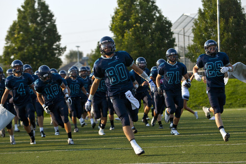 Chris Detrick  |  The Salt Lake Tribune
Juan Diego's Zak Olson (80) and his teammates run onto the field before the game at Juan Diego High School Friday August 24, 2012.
