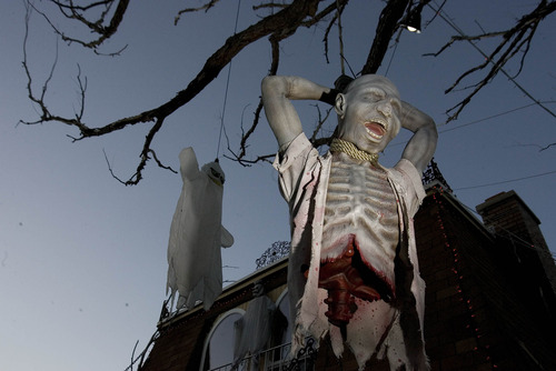 Paul Fraughton | The Salt Lake Tribune
Ghosts and goblins hang from trees in James Gamble's yard. The West Valley City man has transformed his home into a mad scientist's laboratory and his yard into a cemetery for goblins and ghouls.