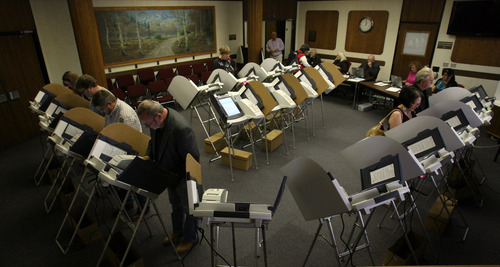 Salt Lake County residents take advantage of the early voting presses as they cast their ballots at Murray City Hall in Murray, Utah Thursday November 1, 2012. Five days before the election, Republican challenger Mitt Romney and President Barack Obama vied forcefully for the mantle of change Thursday in a country thirsting for it after a painful recession and uneven recovery, pressing intense closing arguments in their unpredictably close race for the White House. Early voting topped 20 million ballots. (AP Photo/The Salt Lake Tribune, Steve Griffin)  DESERET NEWS OUT; LOCAL TV OUT; MAGS OUT