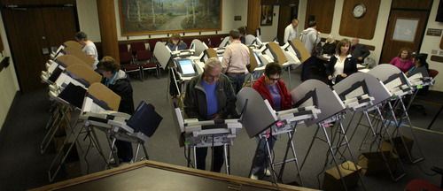 Steve Griffin | The Salt Lake Tribune
Salt Lake County residents take advantage of the early voting presses as they cast their ballots at Murray City Hall in Murray on Thursday.