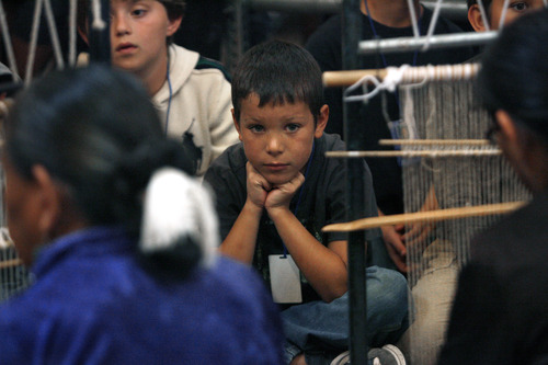 Scott Sommerdorf  |  The Salt Lake Tribune              
Soldier Hollow Elementary School third-grader Quintin Shelton watches Lena Cowboy, left, and others weave as part of the Adopt A Native Elder Program at the Deer Valley Resort, Snow Park Lodge on Thursday. The children visited with American Indian elders and learned weaving skills, history and songs.