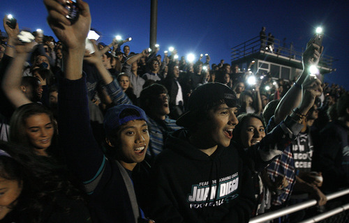 Scott Sommerdorf  |  The Salt Lake Tribune              
During the stadium power outage, Juan Diego students used their cellphones to illuminate the stands, and serenaded Hurricane with "Na Na Na Na, Na Na Na Na, Hey Hey, Goodbye!" Juan Diego beat Hurricane 38-0 in a 3A state quarterfinal playoff game, Friday, November 2, 2012.