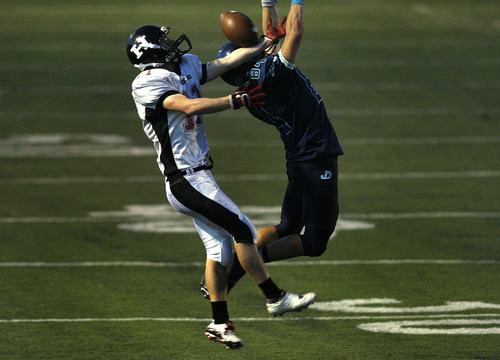 Scott Sommerdorf  |  The Salt Lake Tribune              
Hurricane WR Koy Gubler, #11, could not control this pass while being defended by Juan Diego's DB David Alexander, #84, during second half play. Juan Diego beat Hurricane 38-0 in a 3A state quarterfinal playoff game, Friday, November 2, 2012.