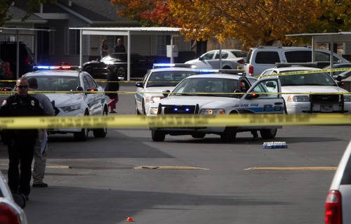 Rick Egan  | The Salt Lake Tribune 

Dozens of West Valley police cars fill the parking lot of the Lexington Park apartments in West Valley City, after a fatal  shooting at the complex, Friday, November 2, 2012.