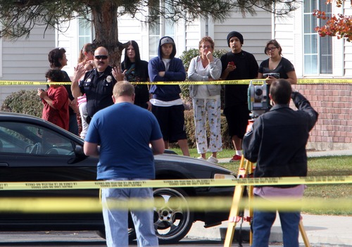 Rick Egan  | The Salt Lake Tribune 

Apartment residents observe the investigation by West Valley police at the Lexington Park apartments in West Valley City, after a fatal shooting at the complex, Friday, November 2, 2012.