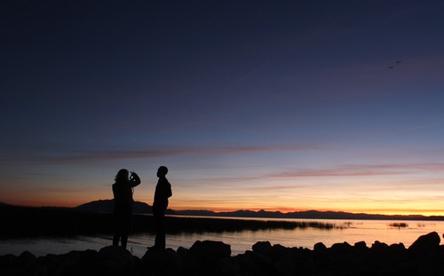 Rick Egan  | The Salt Lake Tribune 

Katie Harmon and Diehl Mutumba, take photos at sunset on the shore of Utah Lake, Sunday evening, November 4, 2012.