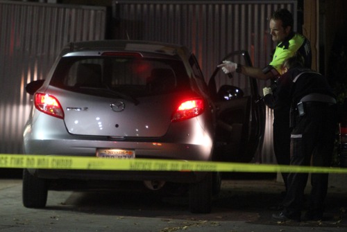 Rick Egan  |  The Salt Lake Tribune 
Investigators check out a silver Mazda at the Shell gas station on 500 East and 2100 South in Salt Lake City, Sunday, November 4, 2012. Two people were shot near 600 East and pulled in to the service station to get help.
