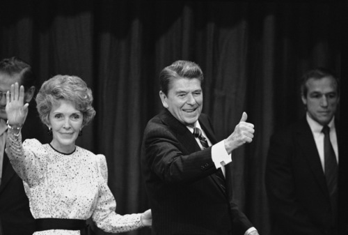 Nancy and Ronald Reagan signal to well-wishers and supporters at the Century Plaza Hotel at night, Tuesday, Nov. 7, 1984 in Los Angeles after Reagan was declared the winner in the 1984 presidential election against Democratic opponent Walter Mondale. (AP Photo)