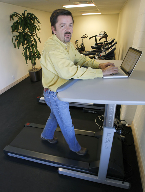 Al Hartmann  |  The Salt Lake Tribune
PCE Fitness President Pete Schenk walks on his company's DT-5 treadmill while working on his laptop. The Salt Lake City compnay's new line of treadmills includes desks with Bluetooth technology built into them.