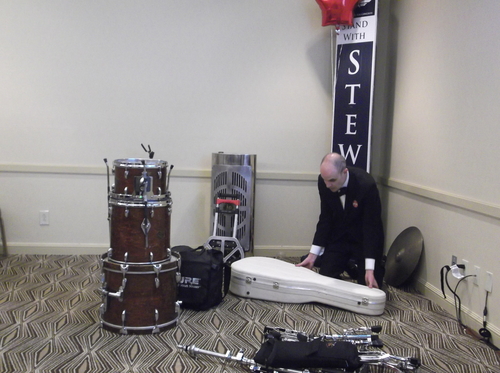 A musician packs up his combo's instruments in a suite at the Salt Lake City Hilton on Tuesday night, as part of the Utah Republican Party's victory celebration was winding down. (photo by Sean P. Means  |  The Salt Lake Tribune)