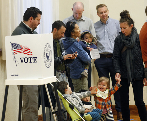 Al Hartmann  |  The Salt Lake Tribune
Parents wait in line to vote Tuesday as their children socialize at Salt Lake Ensign LDS Church at 109 G St. in Salt Lake City. Voting was busy at this polling station.