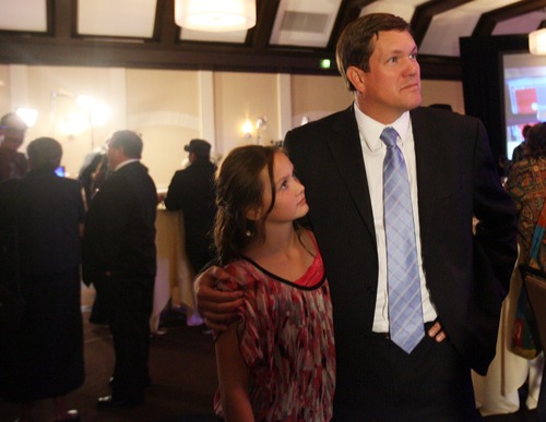 Kim Raff | The Salt Lake Tribune
Utah Attorney General candidate Dee Smith talks to his daughter Sierra Smith while election results come in at the Democrats' election night party at the Sheraton Hotel in Salt Lake City on Tuesday, Nov. 6, 2012.