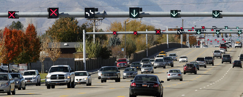 Al Hartmann  |  The Salt Lake Tribune
View looking west down 5400 South at 3200 West Monday. The Utah Department of Transportation has turned on "Flex Lane" lights on 5400 South between Bangerter Highway and near Redwood Road. Beginning Wednesday, lanes will change direction during the day -- with most lanes eastbound in the morning and most lanes switching to westbound in the afternoon and evening rush hour.