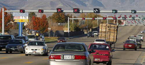 Al Hartmann  |  The Salt Lake Tribune
Morning commuters use reversible flex lanes Wednesday morning Nov. 7, as they begin operation along 5400 South and 3200 West.  At 8:30 a.m. four lanes were open to eastbound traffic and two for westbound. Light bars with lane indicators appear about every 500 feet along 5400 South between Bangerter Highway and 1900 West.