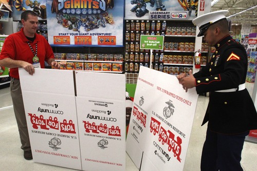 Rick Egan  | The Salt Lake Tribune 
Toys R Us store manager James Cook and U.S. Marine Lance Cpl. Marc Sumampong set up boxes for Toys for Tots at the Murray store. Local Marine units heledp kick off the annual holiday toy drive to benefit the Marine Toys for Tots Foundation.