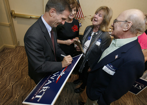 Scott Sommerdorf  |  The Salt Lake Tribune              
2nd District Congressman-elect Chris Stewart is headed to Washington, D.C., for orientation sessions, along with the other 83 newly elected members. This Election Night photo shows Stewart and his wife, Evie, left, signing campaign signs for supporters.