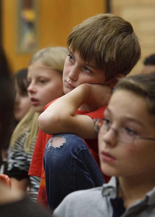 Leah Hogsten  |  The Salt Lake Tribune
Knowlton Elementary 5th grader Riley Downs and his classmates listen as Prisoner of War Veteran Col. Jay Hess of Farmington, Utah shares his experiences Wednesday, November 7, 2012. Hess was a 37-year-old captain in the Air Force in 1967 when his F-105 was shot down. He bailed out and was captured by the North Vietnamese.
Hess spent 5 1/2 years as a prisoner of war at Hoa Lo Prison, which the captives facetiously nicknamed the Hanoi Hilton.