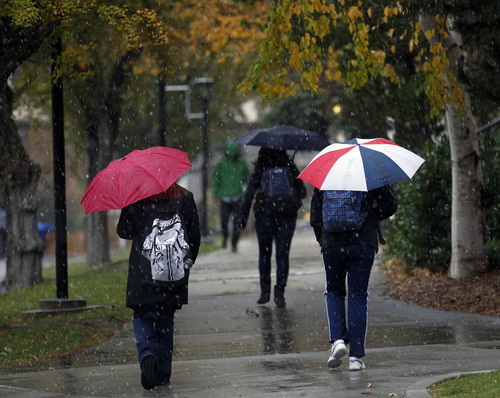 Al Hartmann  |  The Salt Lake Tribune
Foul-weather gear and umbrellas come out Friday morning at the University of Utah as rain turns to sleet. Get used to it for the weekend.