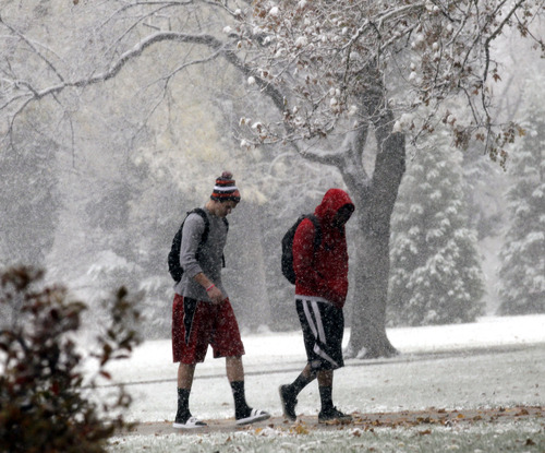 Al Hartmann  |  The Salt Lake Tribune
Two University of Utah students head to class Friday morning at the University of Utah a bit underdressed in shorts and sandals for the falling snow. Old habits die hard as we've gotten used to above-average temperatures for the past month.