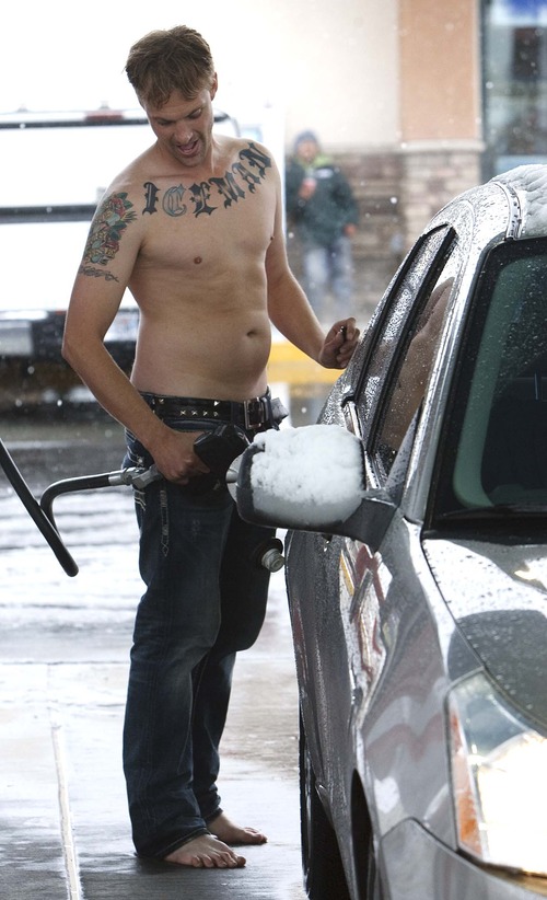 Leah Hogsten  |  The Salt Lake Tribune
Andy Curtis braved the cold and snow without shirt or shoes Friday, November 8, 2012 while fueling up his car in Salt Lake City.