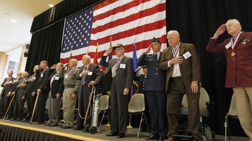 Al Hartmann  |  The Salt Lake Tribune
Eleven American service veterans salute during a Veterans Day ceremony at the University of Utah on Friday, November 9. The men were awarded honorary medals for their exemplary service.