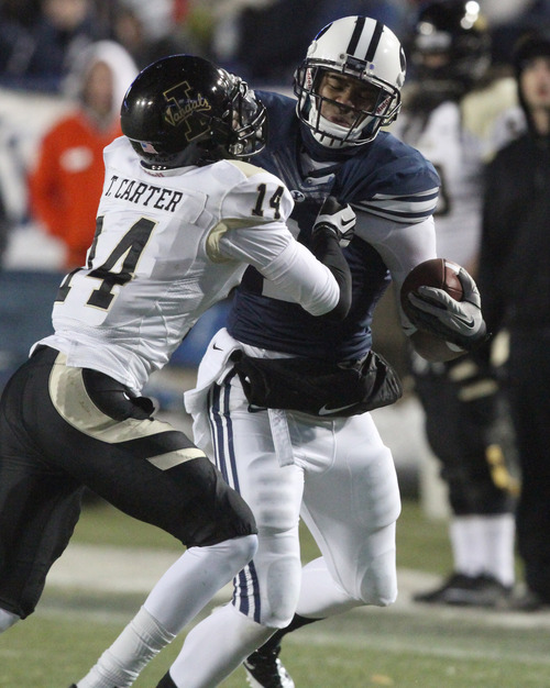 Rick Egan  | The Salt Lake Tribune 

Brigham Young Cougars wide receiver Ross Apo (1) tries to get past Tracey Carter of the Vandals  Lavell Edwards Stadium, Saturday, November 10, 2012