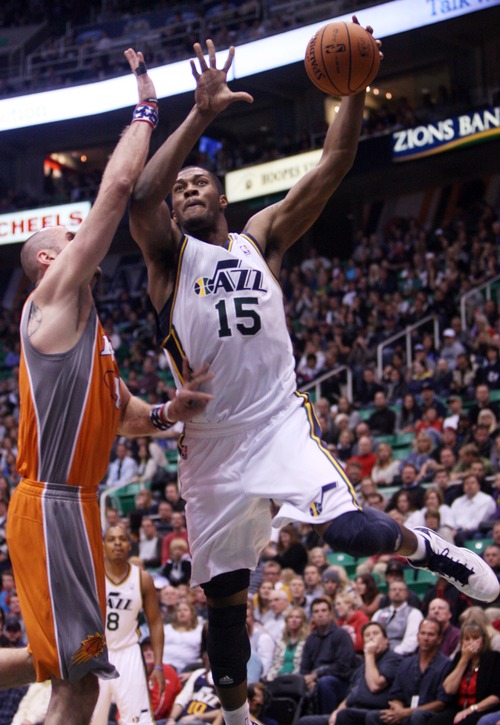 Kim Raff  |  The Salt Lake Tribune
(right) Utah Jazz power forward Derrick Favors (15) attempts a layup as he is defended by Phoenix Suns center Marcin Gortat (4) during a game against the Phoenix Suns at EnergySolutions Arena in Salt Lake City, Utah on November 10, 2012.