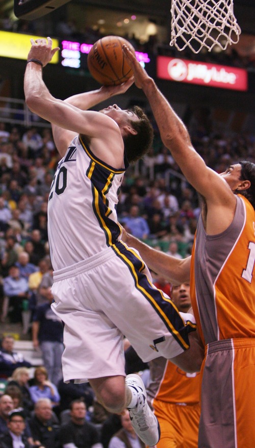 Kim Raff  |  The Salt Lake Tribune
Utah Jazz shooting guard Gordon Hayward (20) is blocked by Phoenix Suns power forward Luis Scola (14) while attempting a layup in the second half at EnergySolutions Arena in Salt Lake City, Utah on November 10, 2012. The Jazz went on to win the game 94-81.