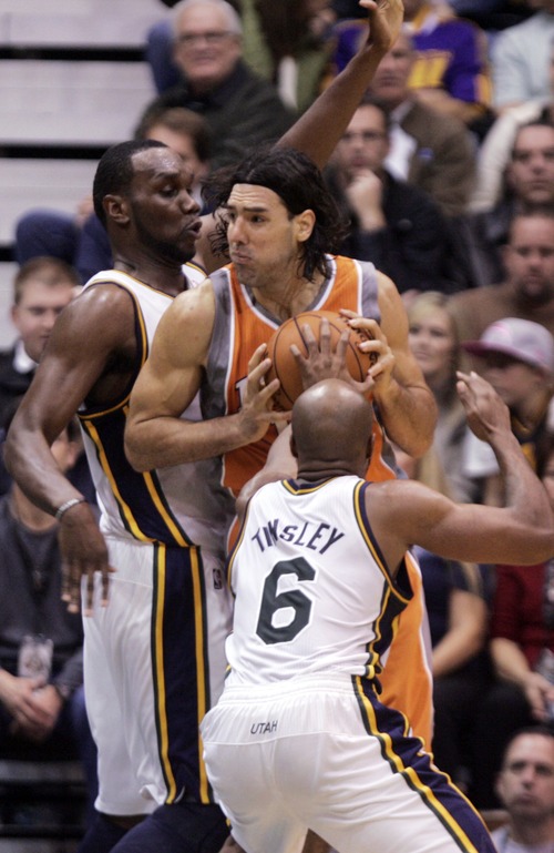 Kim Raff  |  The Salt Lake Tribune
(back) Utah Jazz center Al Jefferson (25) and Utah Jazz point guard Jamaal Tinsley (6) put pressure on Phoenix Suns power forward Luis Scola (14) during the second half at EnergySolutions Arena in Salt Lake City, Utah on November 10, 2012. The Jazz went on to win the game 94-81.