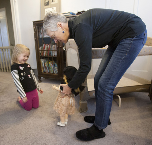 Steve Griffin |  The Salt Lake Tribune
Beverly Miller and her granddaughter, Penny, play with Beverly's childhood dolls Thursday November 8, 2012. Beverly was diagnosed with Alzheimer's when she was 64. Her husband, Bill, retired early to become her full-time caregiver. While she is still verbally and socially engaged, she has trouble with linear sequencing. She can no longer drive and cannot remember where she is in a recipe, or how to dial on a phone or use the computer. Bill says her condition will worsen as time goes on.