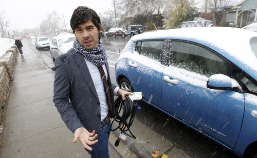 Al Hartmann  |  The Salt Lake Tribune
First-year law student Rodrigo Sagebin holds the 120 volt plug in charger for is Nissan Leaf electric car.  He is one of the first University of Utah  students to drive an electric car, but the university is taking no steps to accommodate early adopters of this green technology, nor will officials allow him to charge it at the student apartments where he lives.