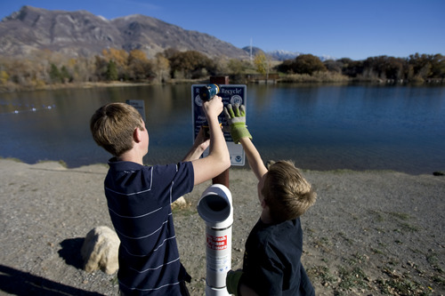 Kim Raff | The Salt Lake Tribune
(left) Carl Petersen and Jeffrey Petersen help to install a monofilament fishing line container at the pond at Highland Glen Park in Highland, Utah on October 29, 2012. Eagle Scouts Steven Petersen and John Petersen decided to do outreach about the dangers of monofilament fishing line to wildlife as their Eagle Scout project and have been able to install these container a few locations near fishing areas.