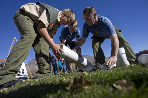 Kim Raff | The Salt Lake Tribune
(left) Eagle Scout John Petersen, Ammon Harris and Scout Master Tony Harris build a container to recycle monofilament fishing line at the pond at Highland Glen Park in Highland, Utah on October 29, 2012. John Peterson decided to do outreach about the dangers of monofilament fishing line to wildlife as his Eagle Scout project and have been able to install these container at a few locations near fishing areas.