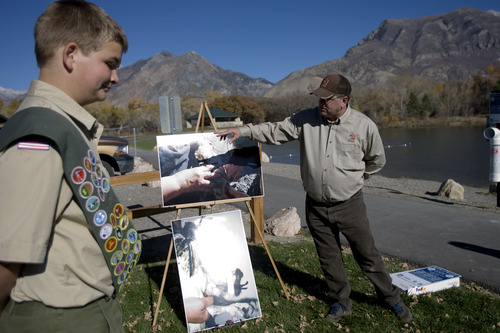 Kim Raff | The Salt Lake Tribune
(left) Eagle Scout John Petersen and Scott Root, DWR outreach specialist, give a presentation about the dangers of monofilament fishing line to wildlife at the pond at Highland Glen Park in Highland, Utah on October 29, 2012. John and Steven Peterson decided to do outreach about the dangers of monofilament fishing line to wildlife as their Eagle Scout project and have been able to install these container a few locations near fishing areas.