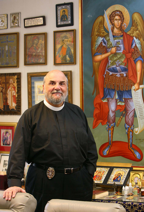 Holladay - Wearing a badge and a collar, Father Michael Kouremetis of the Prophet Elija Greek Orthodox Church also works as a police chaplain for the Midvale Police Department.
The Salt Lake Tribune/Trent Nelson; 2.08.2007