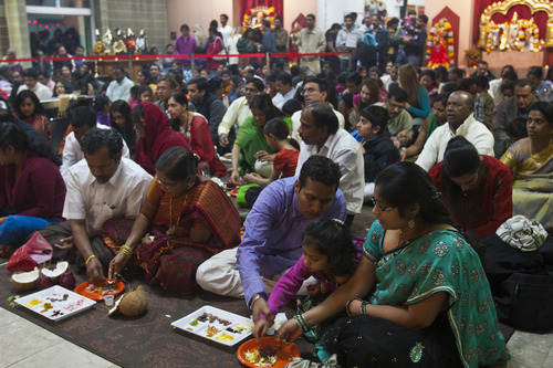 Chris Detrick  |  The Salt Lake Tribune
Swathi Vuppala, Srisha Nalla, 4, and Kasinath Nalla, participate in personal worship during the festival of Diwali at the Sri Ganesha Hindu Temple Tuesday November 13, 2012.