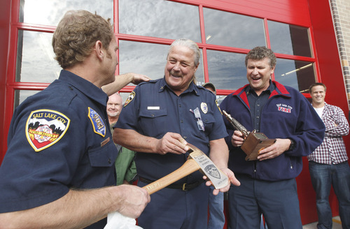 Al Hartmann  |  The Salt Lake Tribune
Fireman Wade Cowley, left, gives an engraved fireman's axe to Battalion Chief Mike Andrew who is retiring after 39 years. Fellow Battalion Chief Mark Carson, right.  Friends and firefighters gathered at Salt Lake City Fire Department Station 1 Wednesday to say goodbye and honor Chief Andrew.  Firefighting is a family tradition with both of his brothers and father serving in the Salt Lake City Fire Department for a combined 108 years.