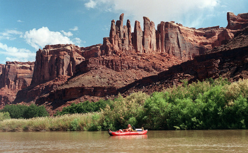 Al Hartmann  |  The Salt Lake Tribune
Camper floats on on the Green River beneath the cliffs in Labyrinth Canyon.