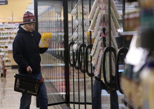 Kim Raff  |  The Salt Lake Tribune
Matt Gyllenskog picks out an item from the freezer while shopping at Smith's Food and Drug in Salt Lake City on Wednesday, Nov. 14, 2012.