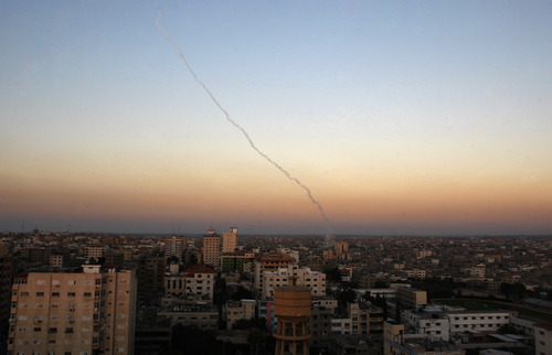 Smoke trails are seen after missiles were fired by Palestinian militants from Gaza City towards southern Israel, Thursday, Nov. 15, 2012. Militants in the Gaza Strip pounded southern Israel with rocket fire on Thursday, killing three people as the Israeli military pressed forward with a second day of intense air raids and naval attacks on militant targets. (AP Photo/Hatem Moussa)