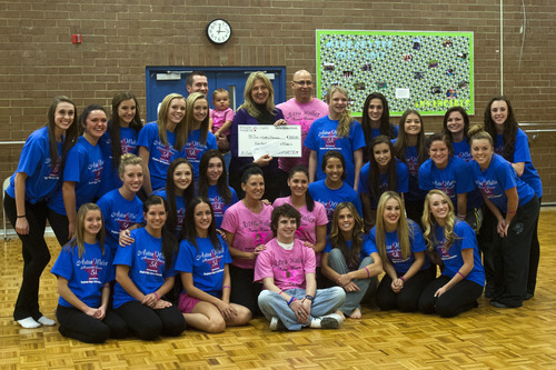 Chris Detrick  |  The Salt Lake Tribune
Members of the Bingham High School Minerettes and members of the Waller family, present a $500 check to Laura Hadley, executive director of the Cystic Fibrosis Foundation. The check was donated in memory of their former teammate, Astra Waller, who died from the disease last year.