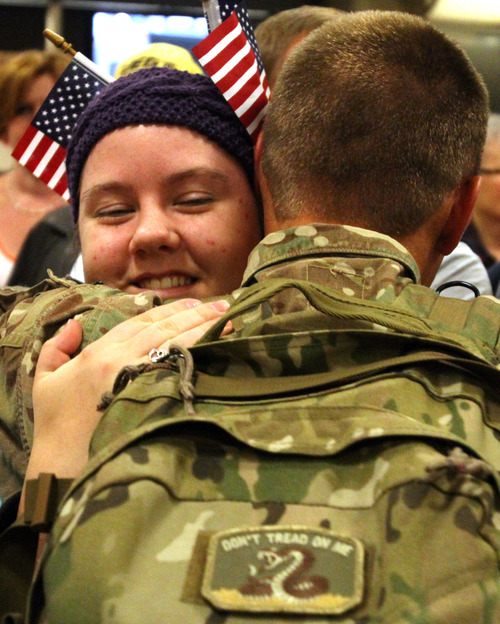 Rick Egan  | The Salt Lake Tribune 

Kyla Williams (left) hugs her brother Colby WIlliams, as he arrives at the Salt Lake City International Airport, Friday, November 16, 2012. Williams was one of 12 airmen from the Utah Air National Guard's 130th Engineering Installation Squadron who returned from a six-month deployment to the Middle East Friday. During their deployment to Qatar and the Persian Gulf region, they installed communications equipment and fiber-optic cable and constructed communications towers.